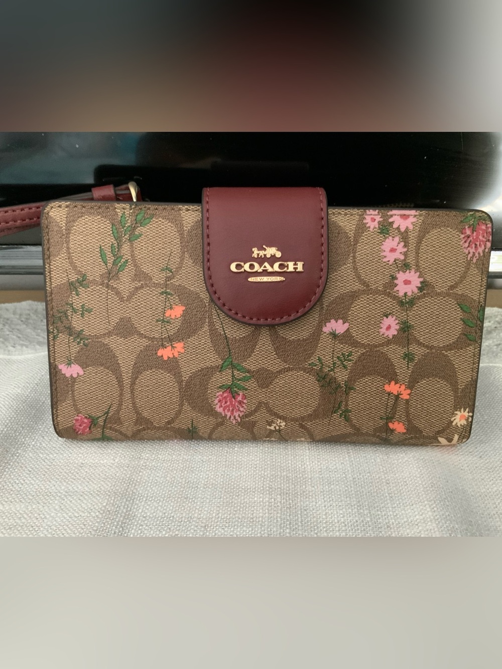 COACH Brown Signature Floral Wristlet with Burgundy Trim